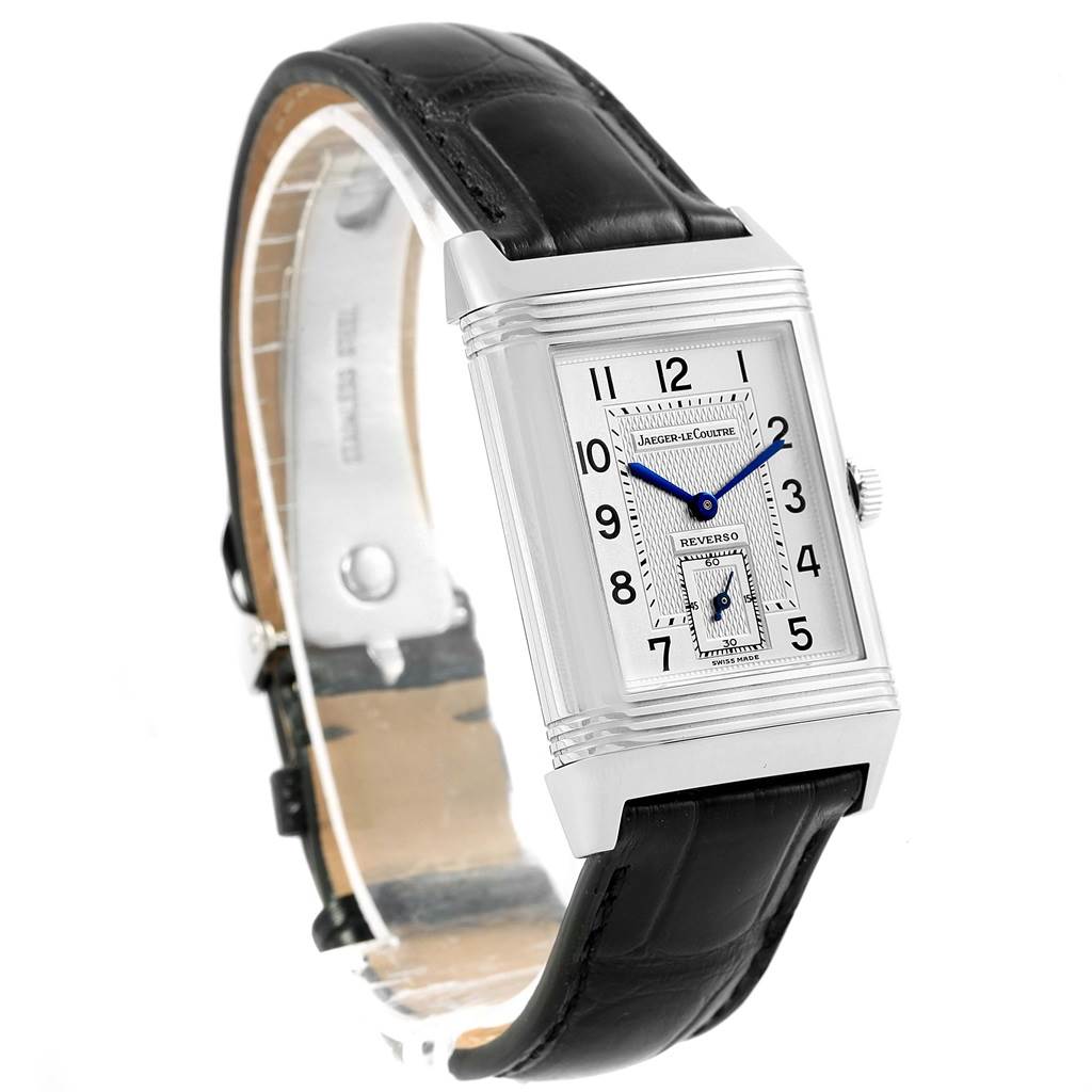 The image shows a close-up, angled view of the Jaeger-LeCoultre Reverso watch, highlighting its face, crown, and leather strap.