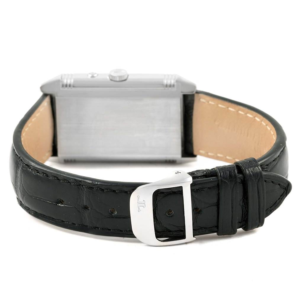 This image shows the back and side view of a Jaeger-LeCoultre Reverso model watch along with its black strap and buckle.