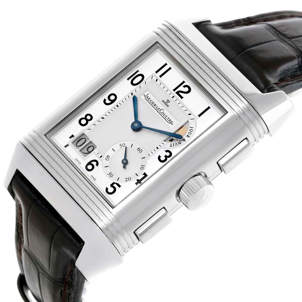 The Jaeger-LeCoultre Reverso watch is shown at an angle with the face, crown, and strap visible.