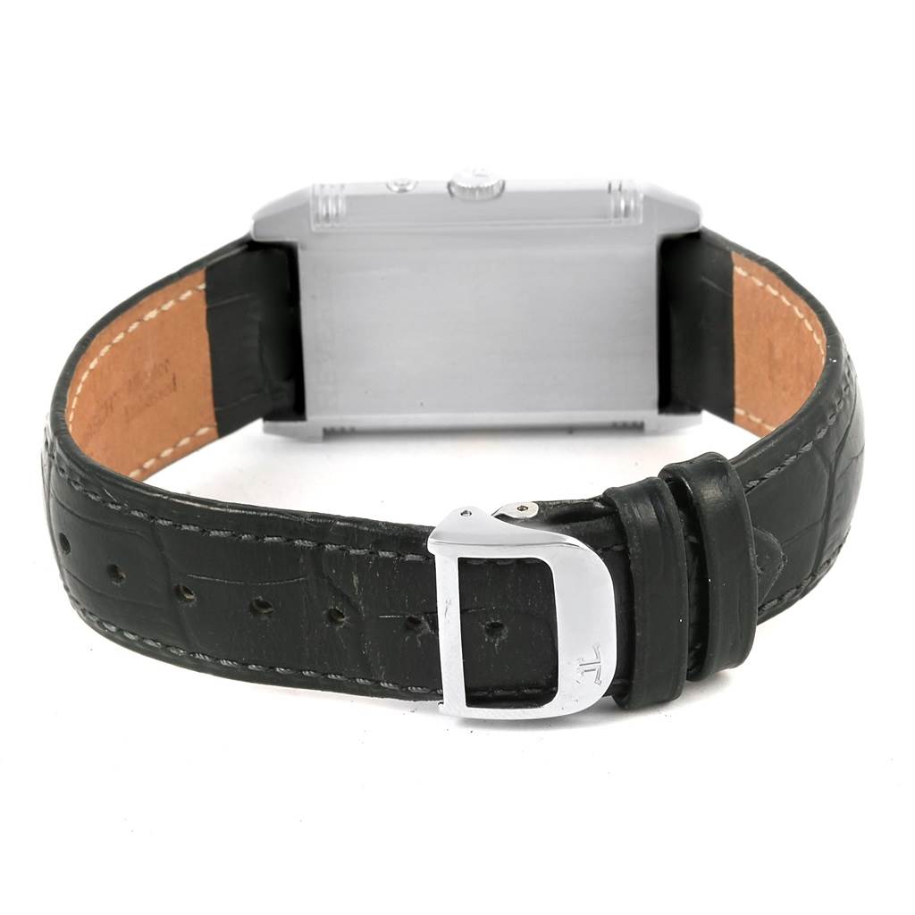The image shows the back side and strap of a Reverso watch by Jaeger LeCoultre, highlighting the metal case and leather band.