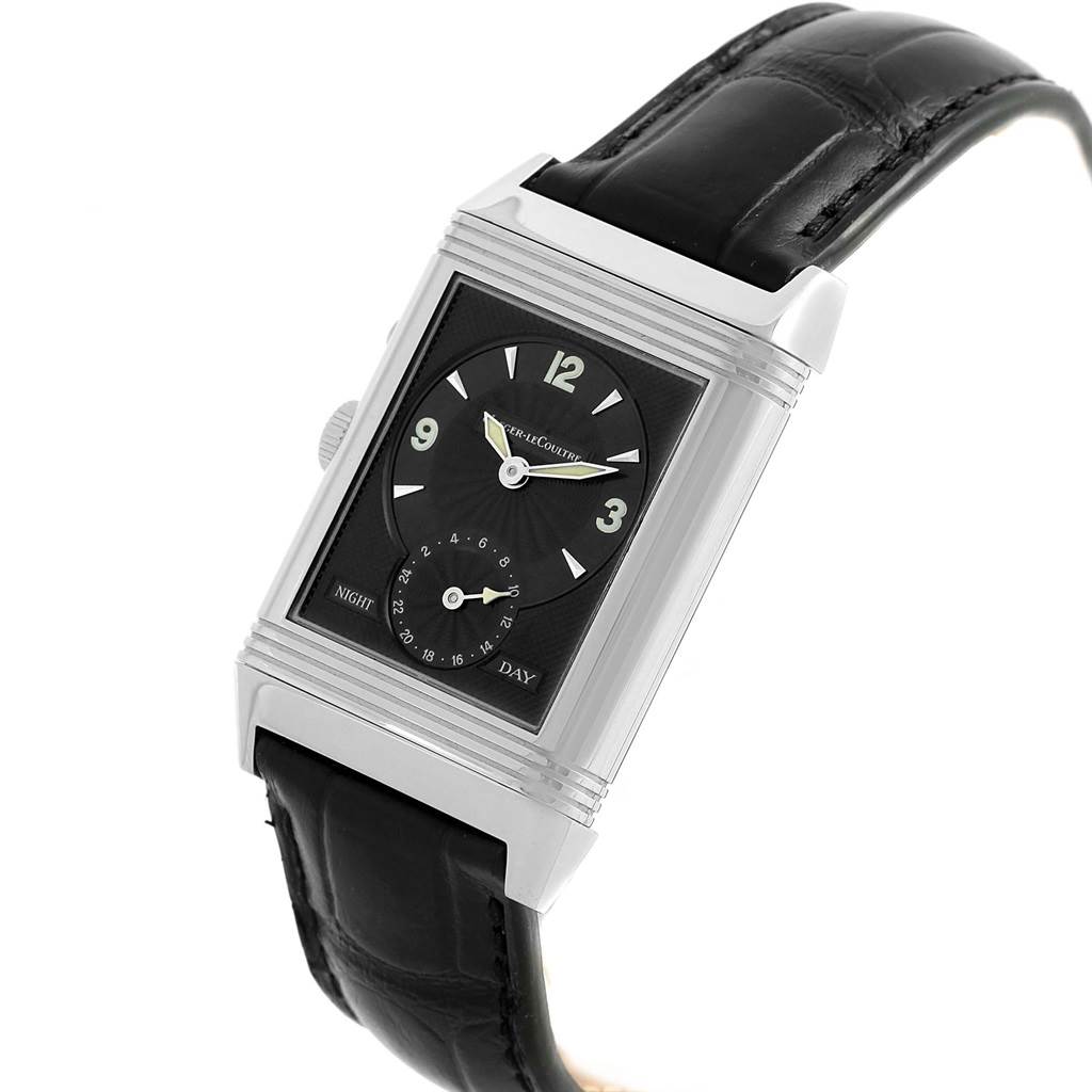 The image shows a Jaeger LeCoultre Reverso Q270854 Men
s Stainless Steel Silver Dial Q270854 Men
s Stainless Steel Silver Dial watch from a three-quarter angle, highlighting its black dial, case, and leather strap.
