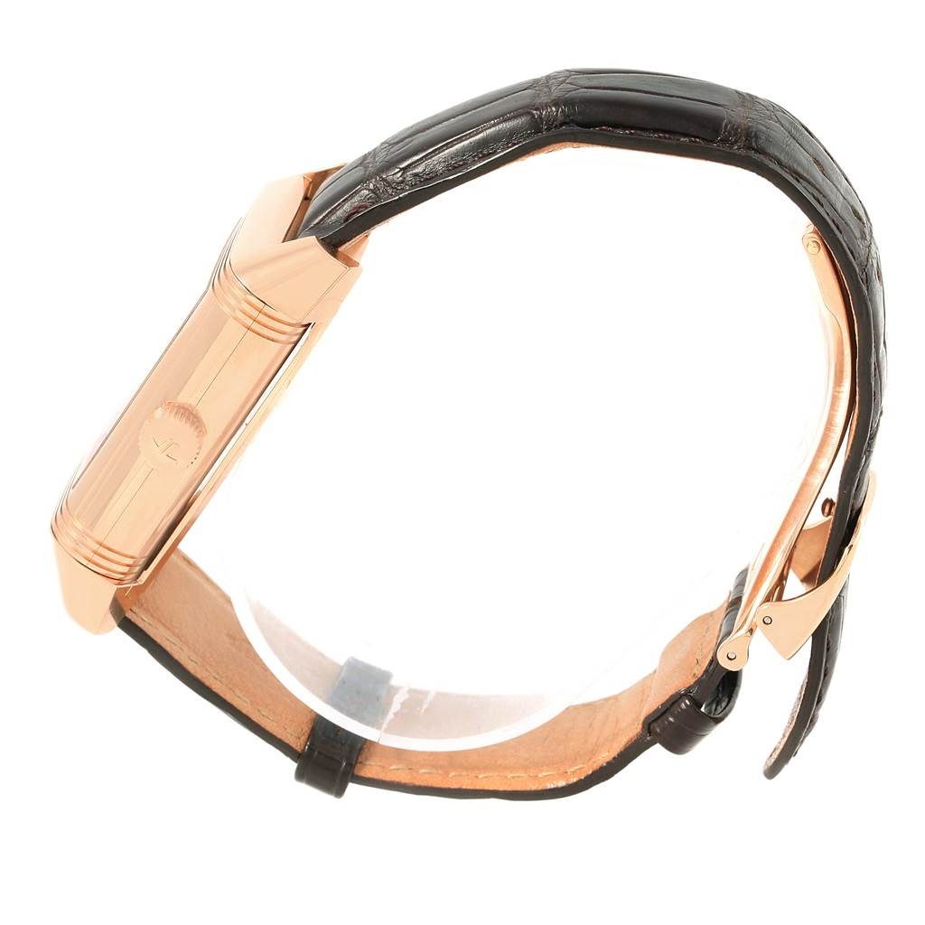 The image shows a side view of a Jaeger LeCoultre Reverso 240.2.72 Men's Rose Gold Silver Dial 240.2.72 Men's Rose Gold Silver Dial watch, highlighting its case, crown, and leather strap.