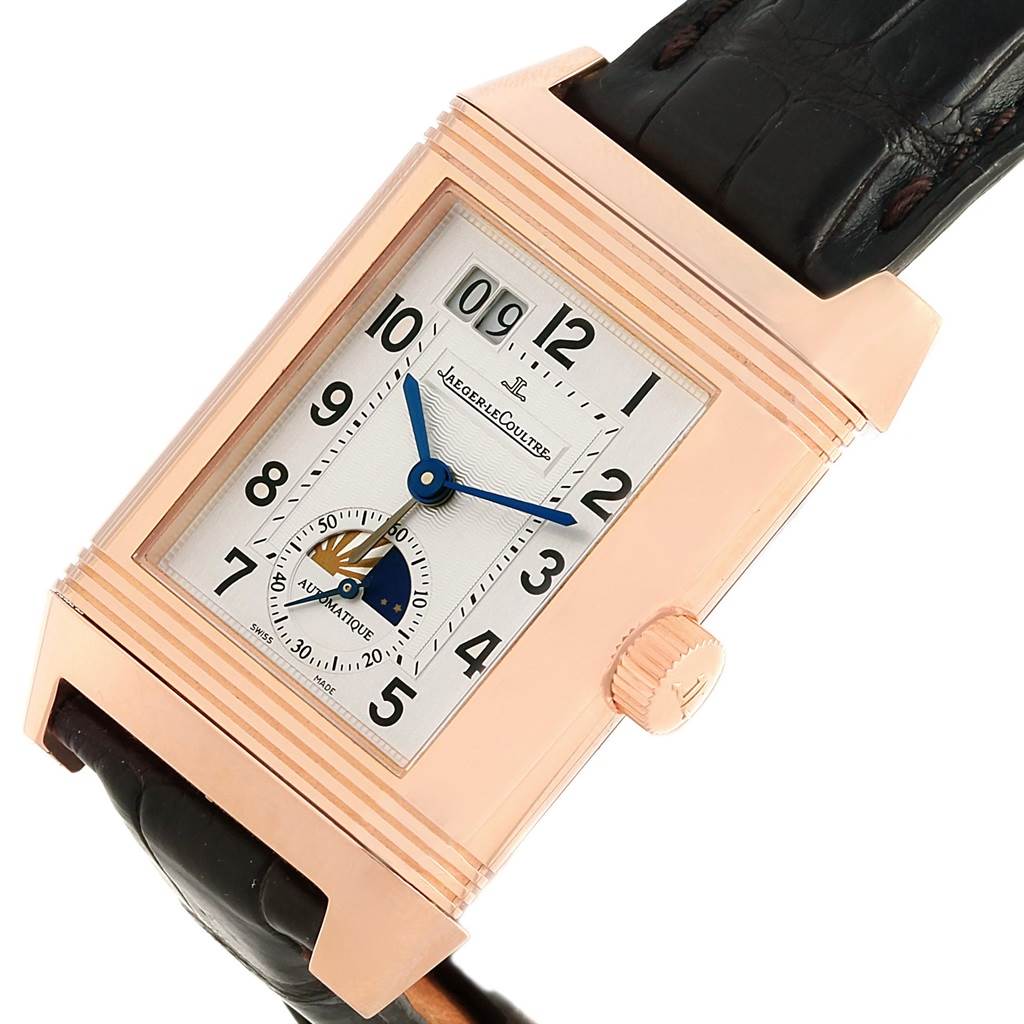 This image shows a Jaeger LeCoultre Reverso 240.2.72 Men's Rose Gold Silver Dial 240.2.72 Men's Rose Gold Silver Dial watch at an angle that highlights the dial, crown, and leather strap.