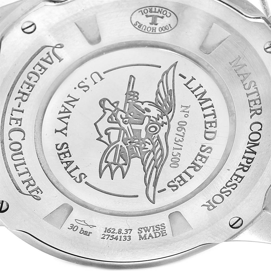 This is an image of the back case of a Jaeger-LeCoultre Master Compressor watch, showing engravings and logos.