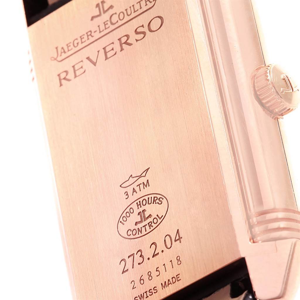 The image shows the side and back of a Jaeger-LeCoultre Reverso watch, featuring engravings, the crown, and the "1000 Hours Control" mark.