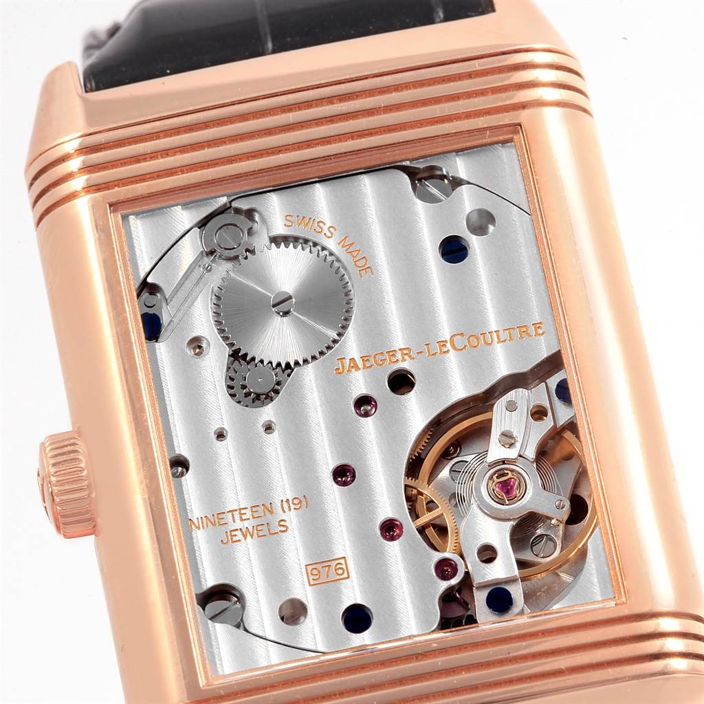 The image shows the movement mechanism of the Jaeger-LeCoultre Reverso watch at an angle emphasizing its inner workings.