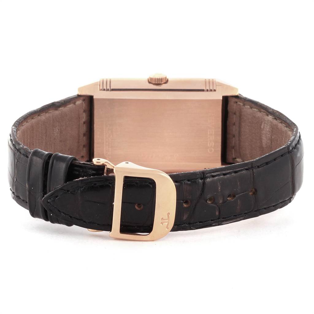 The image shows the back view of a Jaeger-LeCoultre Reverso watch with a focus on the buckle and leather strap.