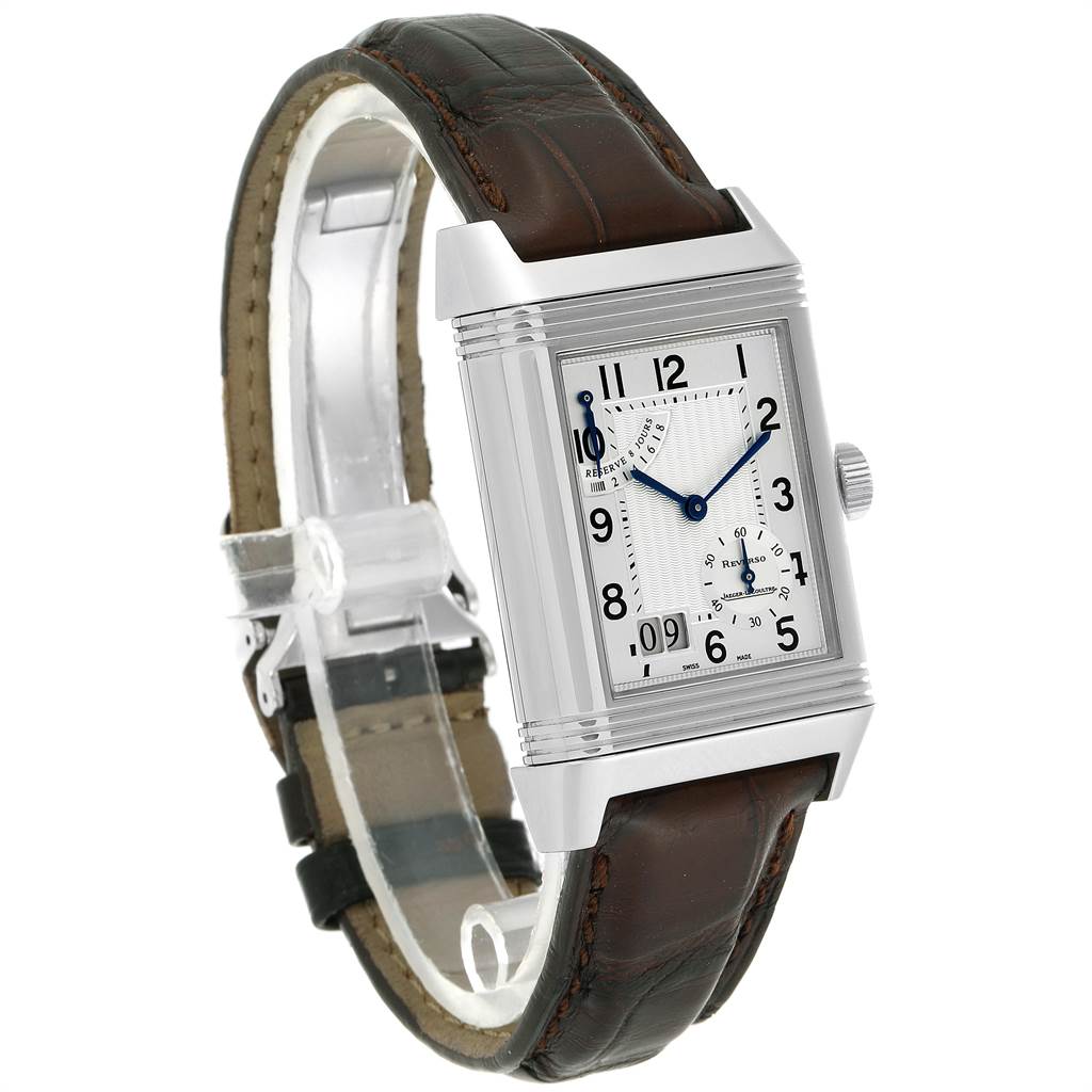 The Reverso model by Jaeger-LeCoultre is shown at an angle displaying the watch face, casing, crown, and brown leather strap.