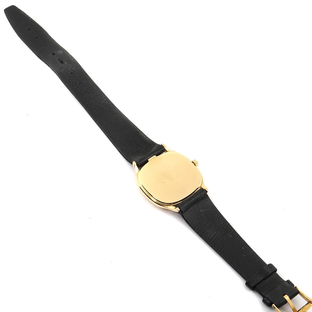 This image shows the back of a Vintage Jaeger LeCoultre watch with a gold case and black leather strap, viewed from a top-down angle.