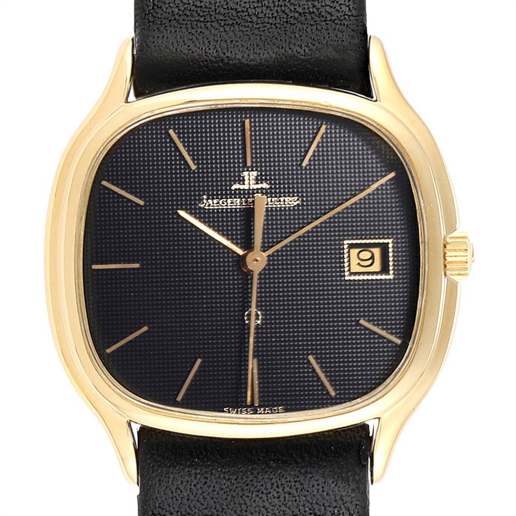 This image shows a front view of a Vintage Jaeger LeCoultre watch, highlighting its dial, date window, and black leather strap.