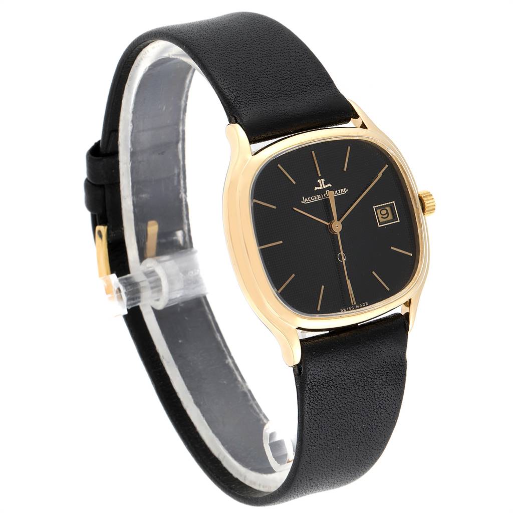 The vintage Jaeger LeCoultre watch is shown from a front angle, displaying the face, case, crown, and strap.