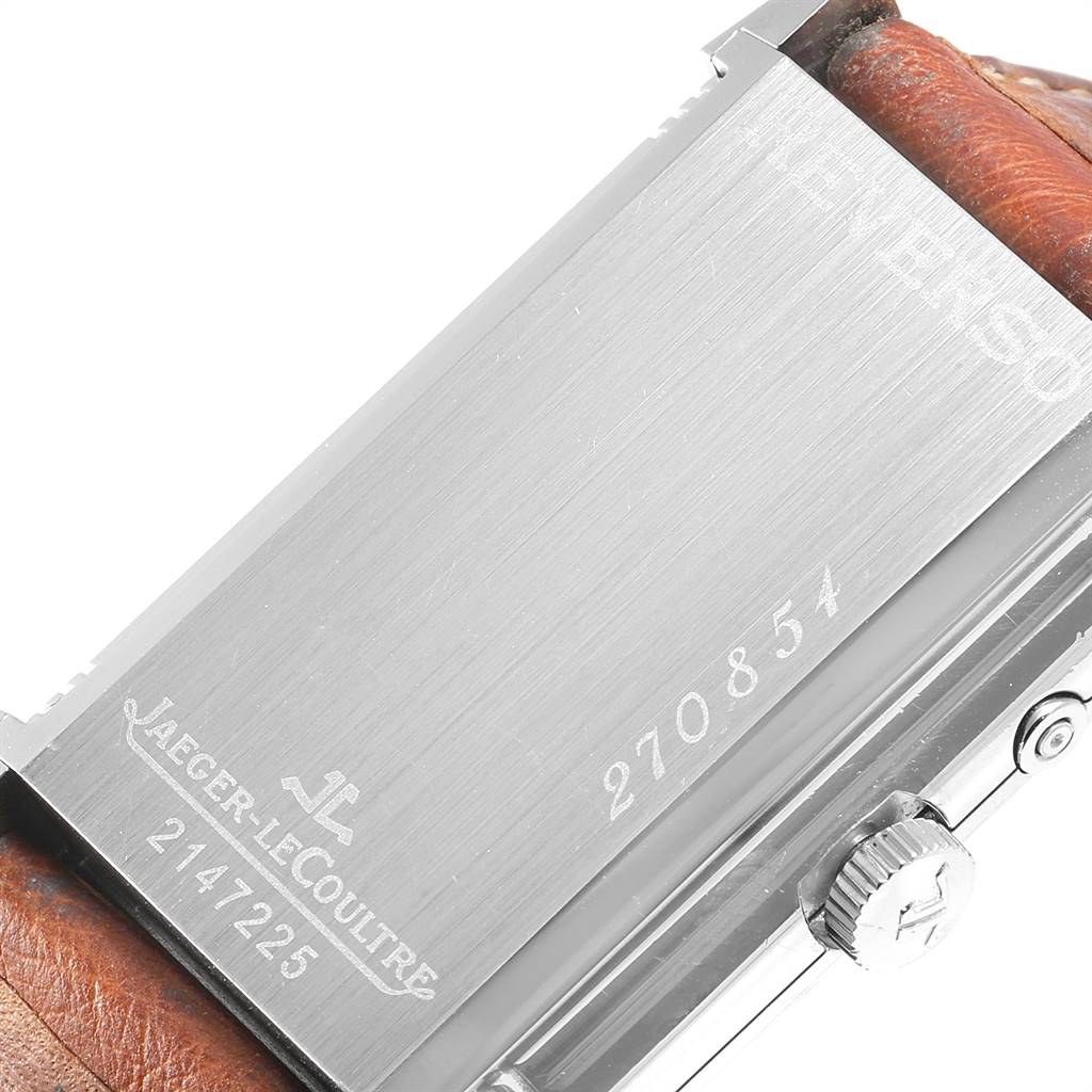 The image shows the back of a Jaeger-LeCoultre Reverso watch, including its casing and part of the leather strap.