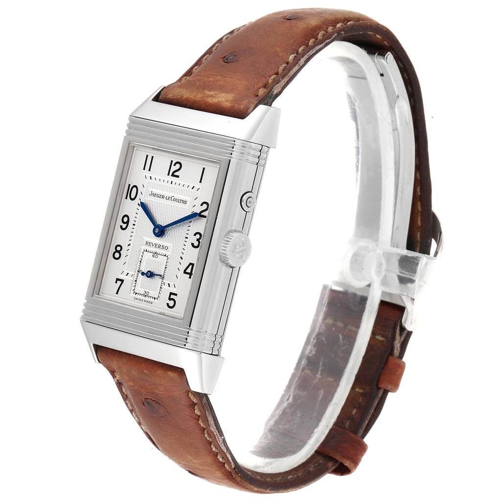 The image shows a Jaeger-LeCoultre Reverso watch from a front angle, highlighting its rectangular face, leather strap, and crown.