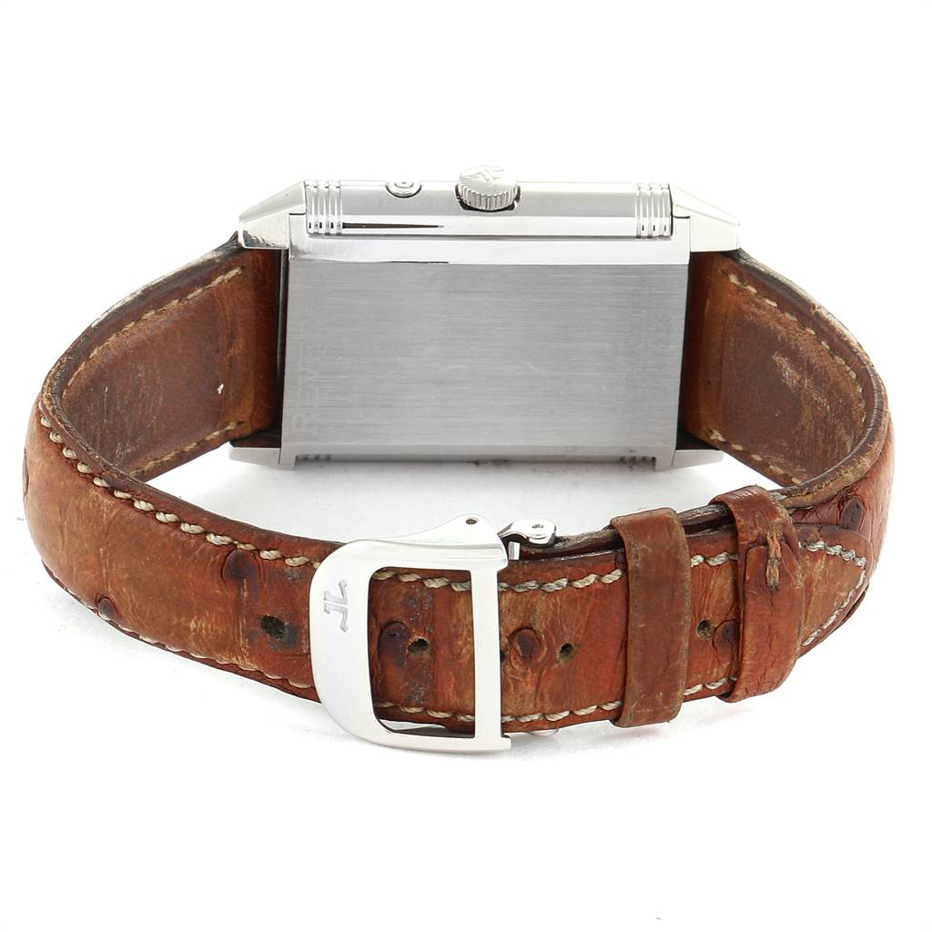 The image shows a Jaeger-LeCoultre Reverso watch from the back, highlighting the case, crown, leather strap, and buckle.