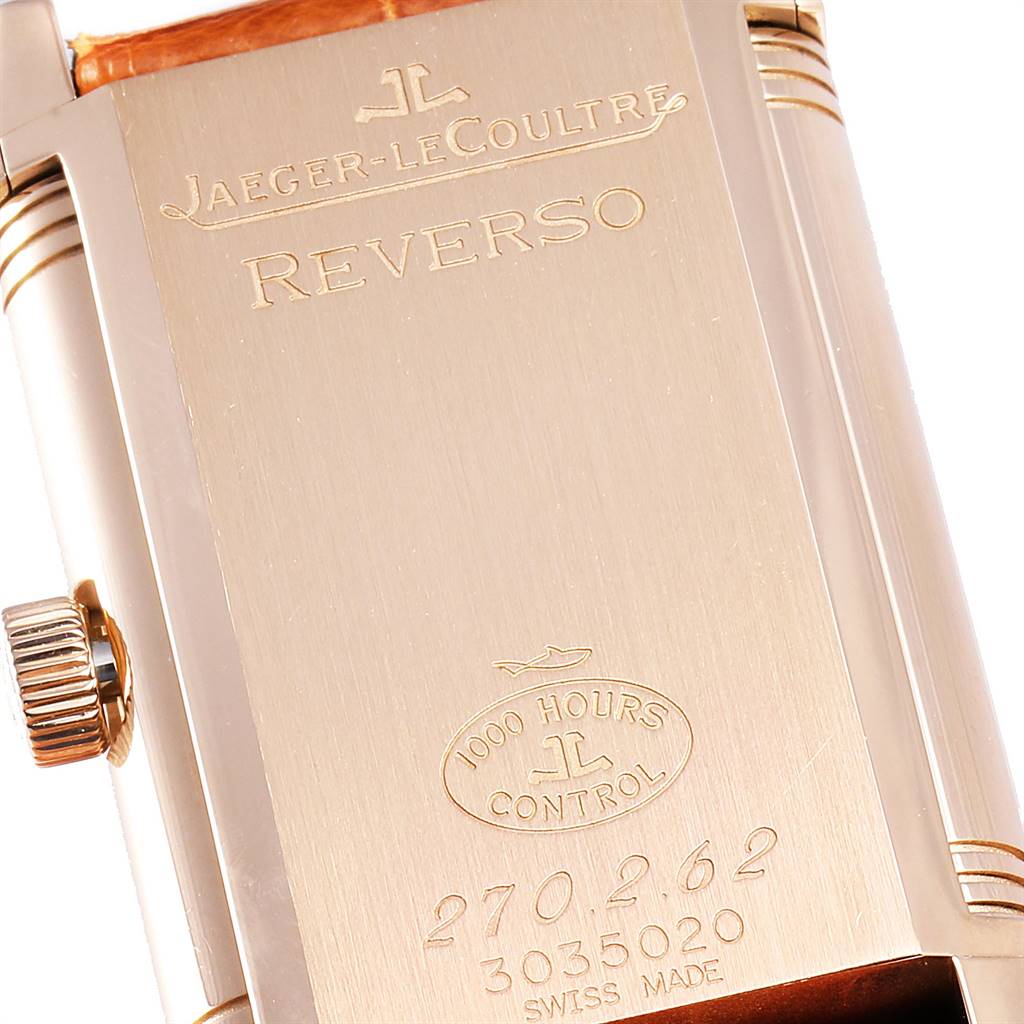 This image shows the back case of a Jaeger-LeCoultre Reverso watch, focusing on its engravings and inscriptions.