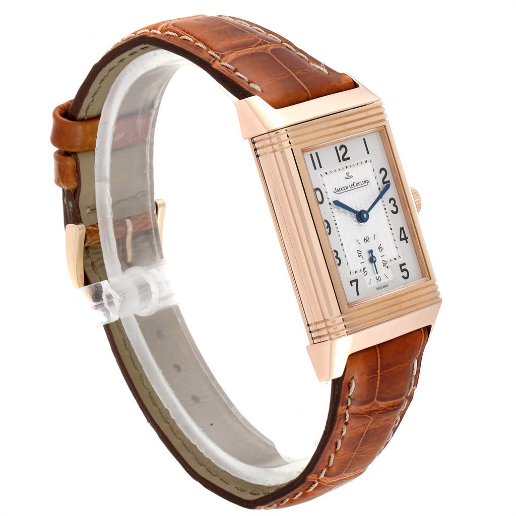 The Jaeger LeCoultre Reverso 270.2.62 Men's Rose Gold Silver Dial 270.2.62 Men's Rose Gold Silver Dial watch is shown at an angled side view, displaying the face, case, and brown leather strap.