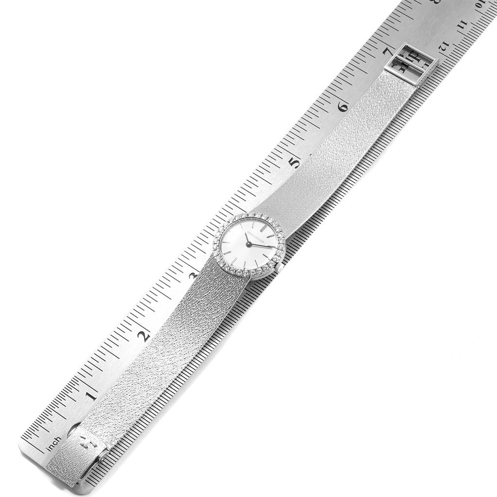 The image shows a top view of a Vintage Jaeger LeCoultre watch laid along a ruler, displaying its face, strap, and buckle.