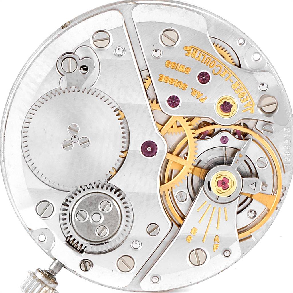 This image shows an internal view of the Vintage Jaeger LeCoultre watch movement, displaying gears and mechanical components.