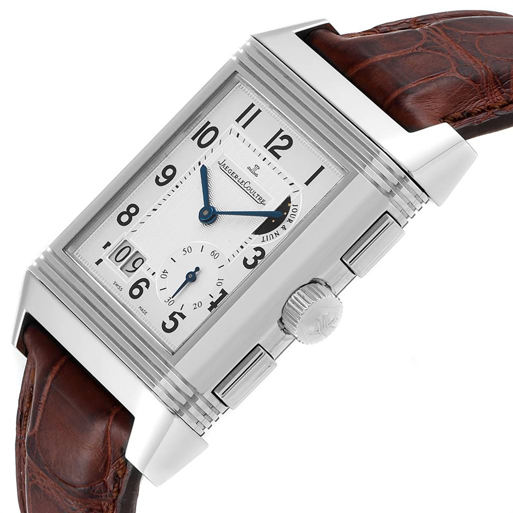 This image shows a Jaeger LeCoultre Reverso Q3028420 Men's Stainless Steel Silver Dial Q3028420 Men's Stainless Steel Silver Dial watch at an angle highlighting the face, crown, and leather strap.