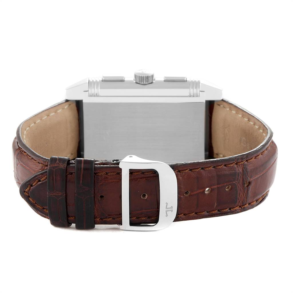 The image shows the back of the Jaeger-LeCoultre Reverso watch and its brown leather strap with a metal buckle.