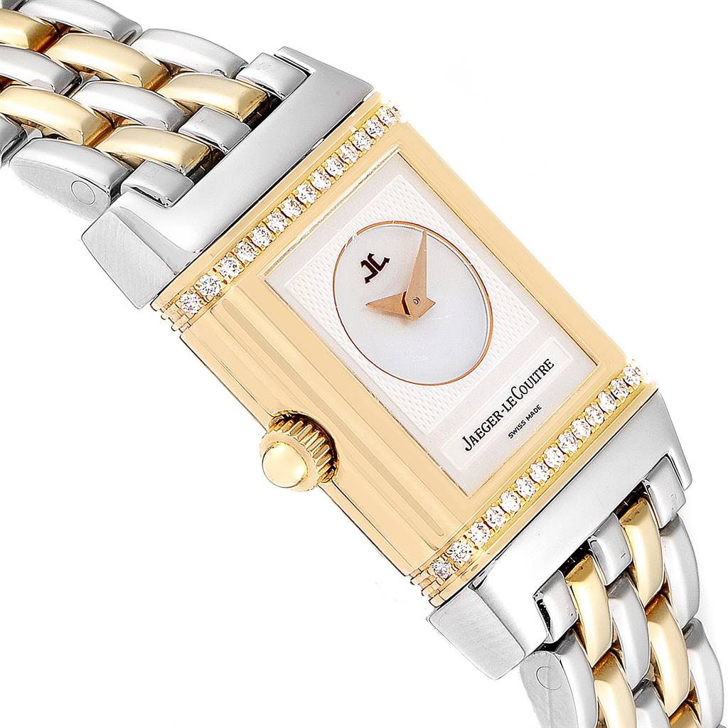 The image shows a Jaeger-LeCoultre Reverso watch at an angle highlighting its face, crown, and part of its two-tone bracelet.
