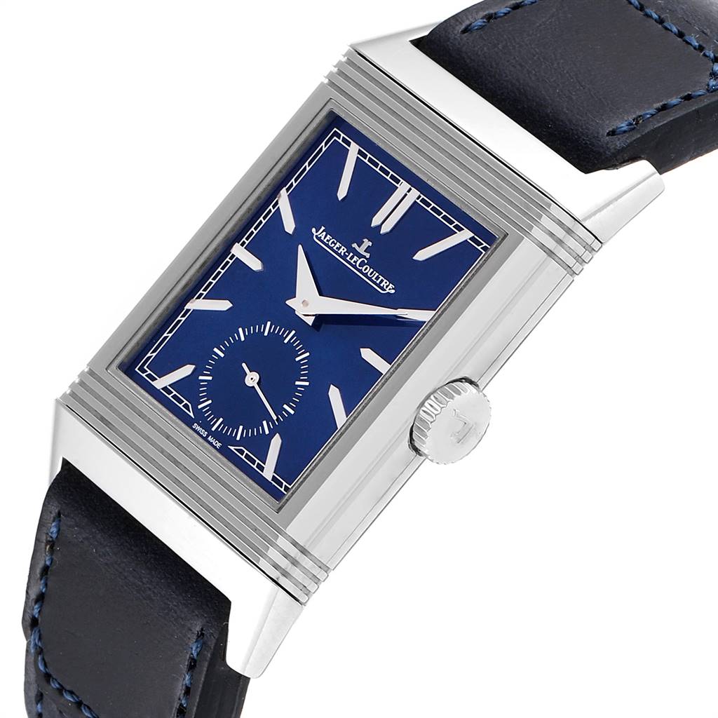 The image shows a close-up angle of a Jaeger LeCoultre Reverso Q3978480 Men's Stainless Steel Blue Dial Q3978480 Men's Stainless Steel Blue Dial watch, highlighting its blue dial, crown, and partly visible leather strap.