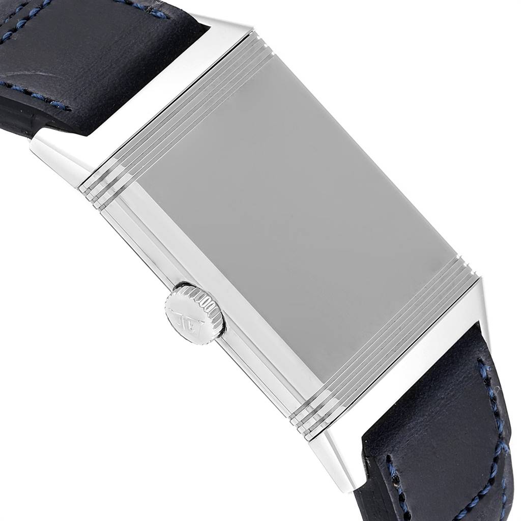 The image shows a close-up side view of the Jaeger LeCoultre Reverso Q3978480 Men's Stainless Steel Blue Dial Q3978480 Men's Stainless Steel Blue Dial's case with its crown and part of the leather strap.