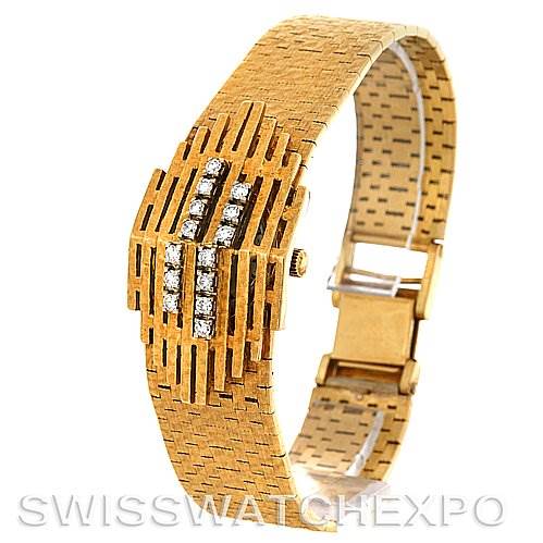 This image shows a Jaeger LeCoultre Vintage Women
s Yellow Gold Silver Dial Women
s Yellow Gold Silver Dial watch at an angle that highlights its intricate gold design and diamond accents on the bracelet.