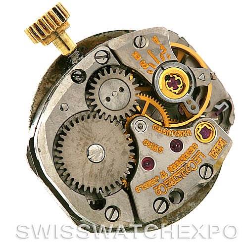 This image shows the movement and internal gears of a vintage Jaeger LeCoultre watch, viewed from an angled top perspective.