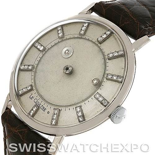 The image shows a vintage Jaeger LeCoultre watch from a slightly angled view, showcasing the dial, crown, and leather strap.