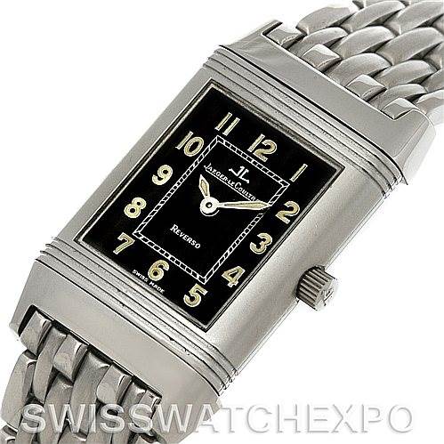 The image shows a Reverso watch by Jaeger LeCoultre from a front angle, highlighting the rectangular face and metal bracelet.