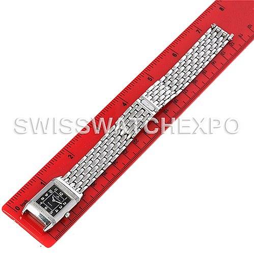 The image shows a Jaeger LeCoultre Reverso 261.8.86 Women's Stainless Steel Grey Dial 261.8.86 Women's Stainless Steel Grey Dial watch laid flat next to a red ruler, displaying the watch face and full metal bracelet.