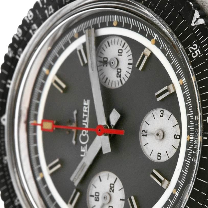 The image shows a close-up of the dial and bezel of a Vintage Jaeger LeCoultre watch with visible sub-dials and the brand name.