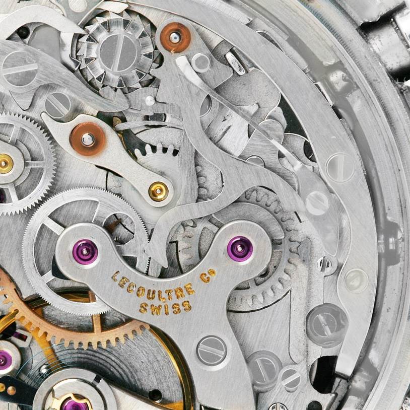 Close-up view of the intricate inner mechanical movements and gears of a Vintage Jaeger-LeCoultre watch.