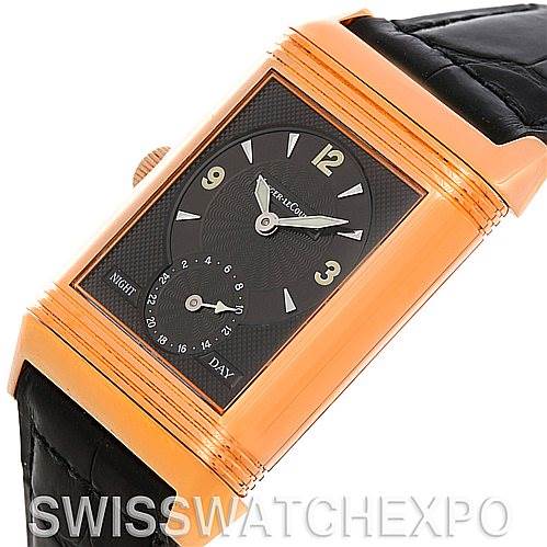 The image shows a Jaeger-LeCoultre Reverso watch at an angled view, highlighting the face, crown, and black leather strap.