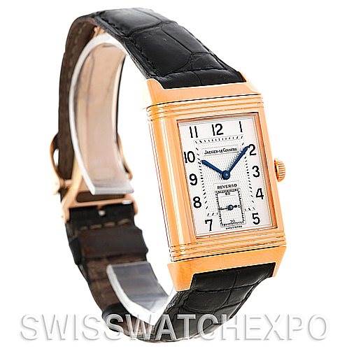 The image shows a Jaeger-LeCoultre Reverso watch at a three-quarter angle, highlighting the dial, case, crown, and leather strap.