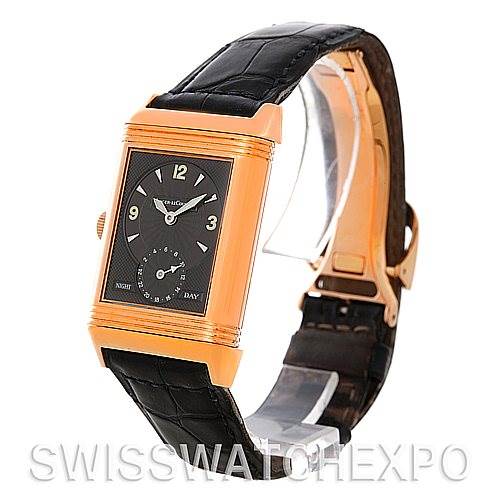 The image shows a front angled view of a Jaeger LeCoultre Reverso 270.254 Men's Rose Gold Silver Dial 270.254 Men's Rose Gold Silver Dial watch with a black strap and gold case, displaying its dial and clasp.