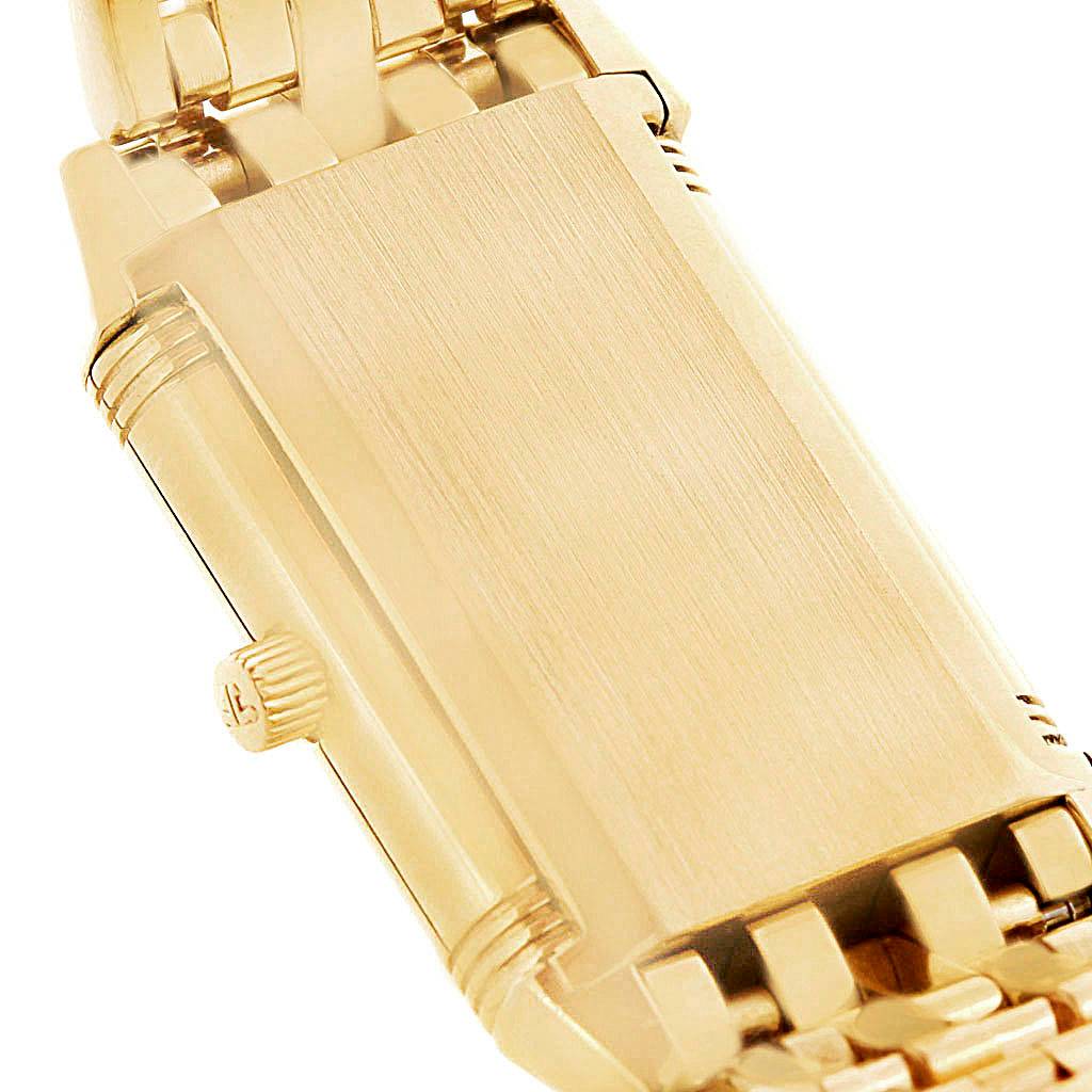 This image shows the reverse side and crown of a gold Jaeger LeCoultre Reverso Q2611110 Women's Yellow Gold Silver Dial Q2611110 Women's Yellow Gold Silver Dial watch, highlighting its bracelet and case details.