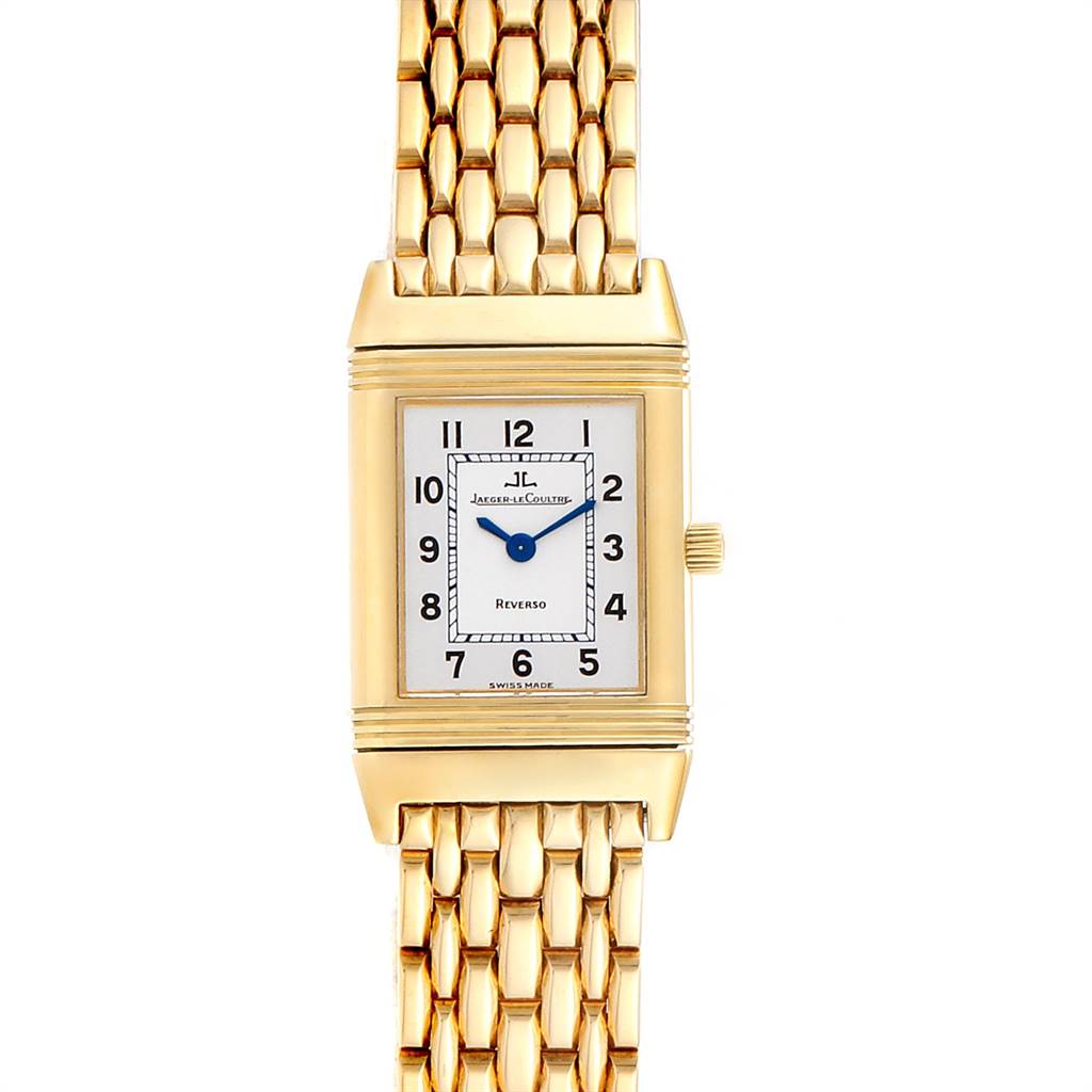The image shows a front view of a Jaeger LeCoultre Reverso Q2611110 Women's Yellow Gold Silver Dial Q2611110 Women's Yellow Gold Silver Dial watch, including its rectangular dial and gold woven bracelet.