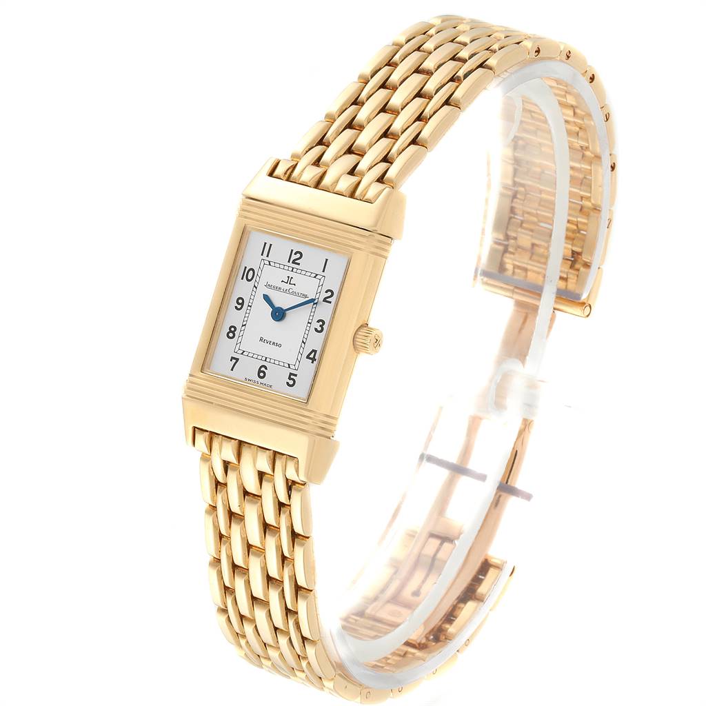 This image shows a gold Jaeger LeCoultre Reverso Q2611110 Women's Yellow Gold Silver Dial Q2611110 Women's Yellow Gold Silver Dial watch at a three-quarter angle, highlighting the rectangular face and bracelet.