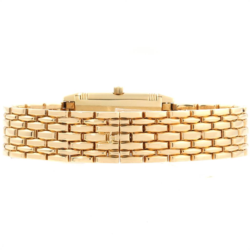 This image shows a side view of the Jaeger LeCoultre Reverso Q2611110 Women's Yellow Gold Silver Dial Q2611110 Women's Yellow Gold Silver Dial watch, highlighting its golden bracelet and crown.