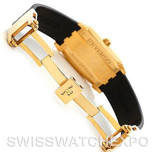 The image shows the back of the Jaeger LeCoultre Reverso 290160 Men
s Yellow Gold Silver Dial 290160 Men
s Yellow Gold Silver Dial watch and the clasp of its strap from an angled view.