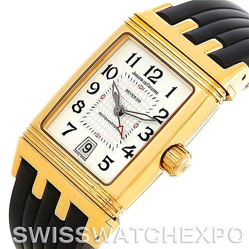 This image shows a Jaeger LeCoultre Reverso 290160 Men
s Yellow Gold Silver Dial 290160 Men
s Yellow Gold Silver Dial watch from an oblique top view, highlighting its rectangular dial, gold case, and black strap.