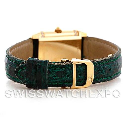 This image shows a rear view of a Jaeger LeCoultre Reverso 265108 Women's Yellow Gold Silver Dial 265108 Women's Yellow Gold Silver Dial watch, highlighting its green strap and gold buckle.