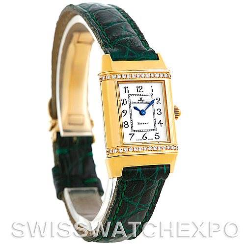 The image shows a Jaeger-LeCoultre Reverso watch from a slight side angle, highlighting the face, bezel, and green leather strap.