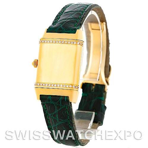 This image shows a side view of the Jaeger LeCoultre Reverso 265108 Women's Yellow Gold Silver Dial 265108 Women's Yellow Gold Silver Dial watch, highlighting its gold casing, crown, and green leather strap.