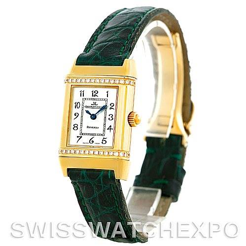 The image shows a Jaeger-LeCoultre Reverso watch angled slightly to the right, highlighting its face, case, crown, and green strap.