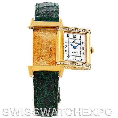 The image shows a Jaeger LeCoultre Reverso 265108 Women's Yellow Gold Silver Dial 265108 Women's Yellow Gold Silver Dial watch in a front view, with the face swiveled out to reveal the back panel on a green strap.