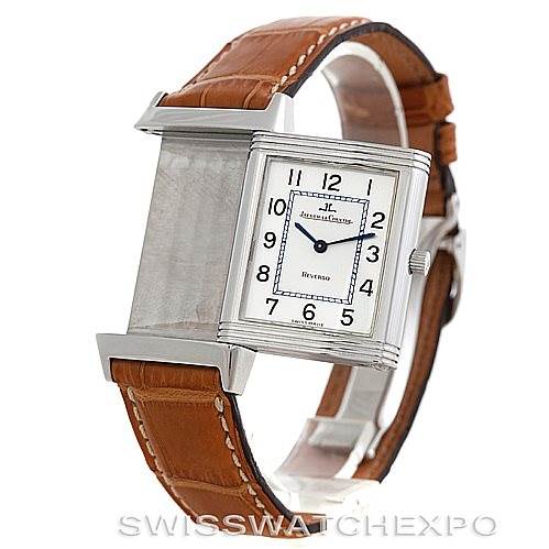 The Jaeger-LeCoultre Reverso watch is shown from an angled view, highlighting its case, dial, and brown leather strap.