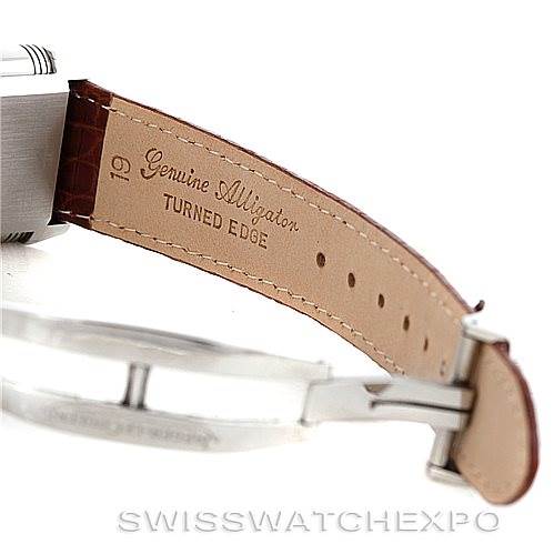 The image shows a close-up of the strap and buckle of a Jaeger-LeCoultre Reverso watch, highlighting the genuine alligator leather strap.